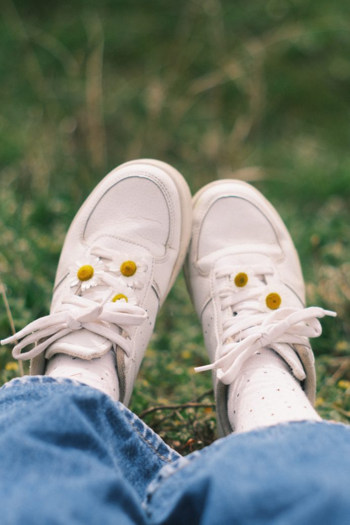 Photo by Ebru Akal: https://www.pexels.com/photo/white-sport-shoes-on-feet-of-person-sitting-on-grass-12484292/