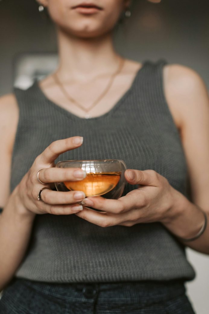 Photo by Vlada Karpovich: https://www.pexels.com/photo/close-up-of-woman-holding-a-glass-with-tea-6802900/