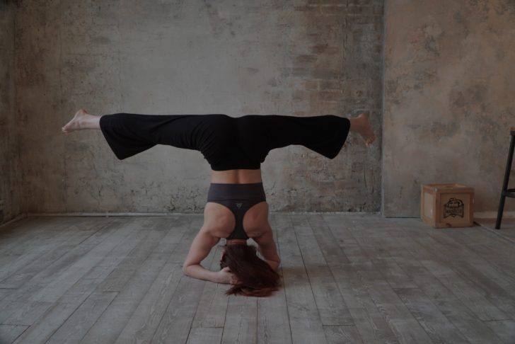 Photo by Alisa Foxy: https://www.pexels.com/photo/woman-in-black-bell-bottom-pants-making-a-headstand-17145047/