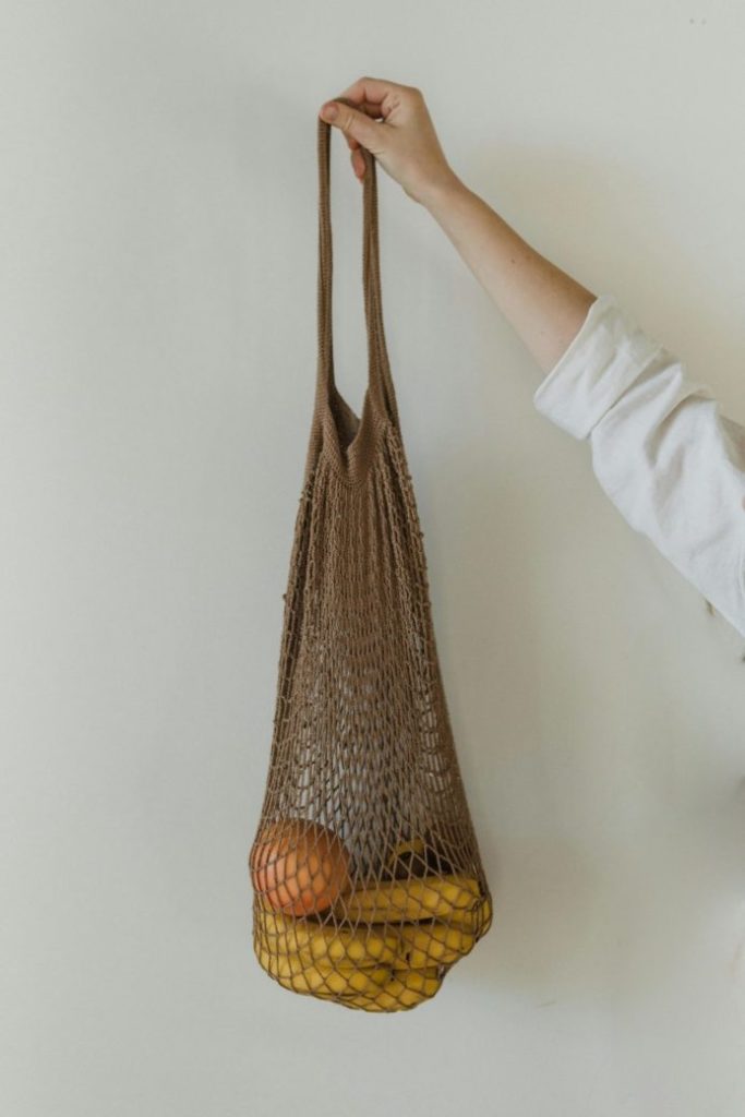 Photo by Arina Krasnikova: https://www.pexels.com/photo/a-person-holding-brown-crocheted-bag-with-bananas-and-mandarin-fruit-6654128/