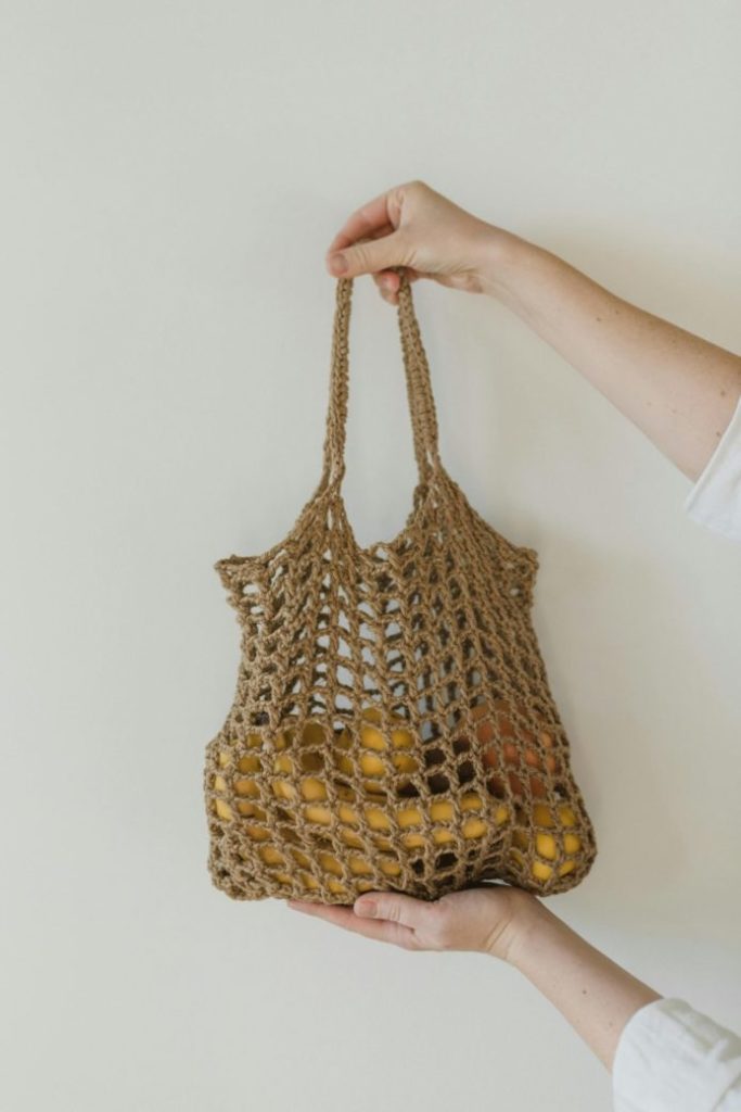Photo by Arina Krasnikova: https://www.pexels.com/photo/a-person-holding-a-brown-crocheted-bag-with-assorted-fruits-6654139/