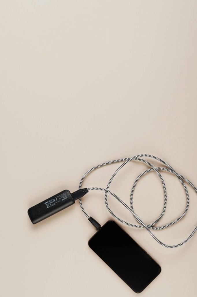 Photo by Karolina Grabowska: https://www.pexels.com/photo/overhead-shot-of-a-cellphone-charging-from-a-power-bank-5208777/