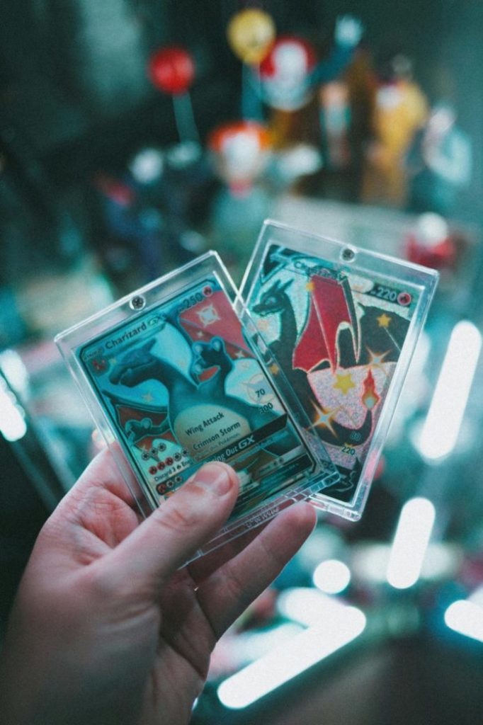 Photo by Erik Mclean: https://www.pexels.com/photo/a-person-holding-a-pokemon-trading-card-9343494/