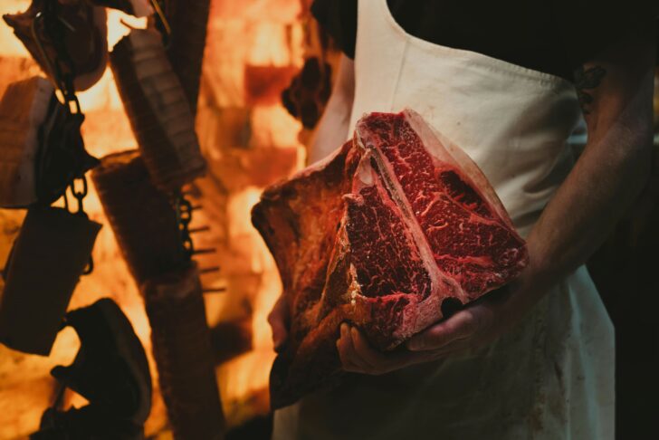 Photo by Dana Sredojevic: https://www.pexels.com/photo/a-butcher-holding-a-slab-of-steak-13279400/